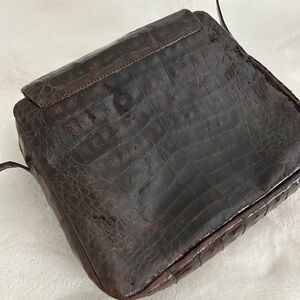 Crocodile chocolate mini crossbody with multiple zipper pockets.